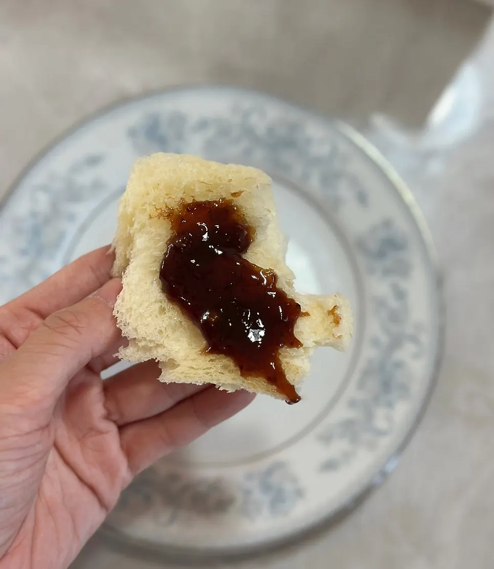 A slice of Golden Beurre milk bread topped with strawberry jam