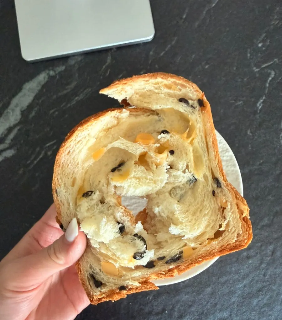 Sliced milk bread served on a plate with cream cheese