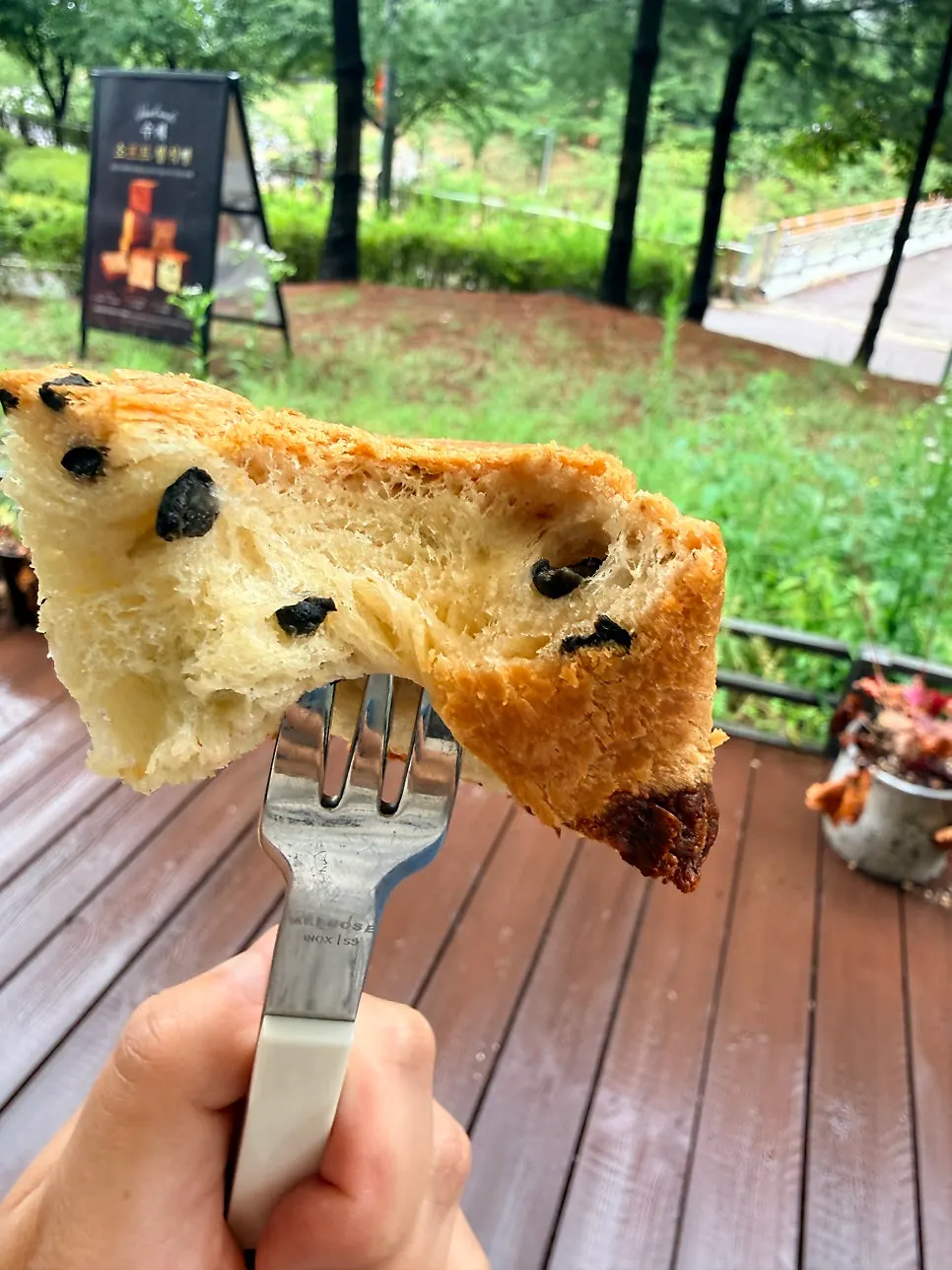 Inside of the bread showing black olives and cheese