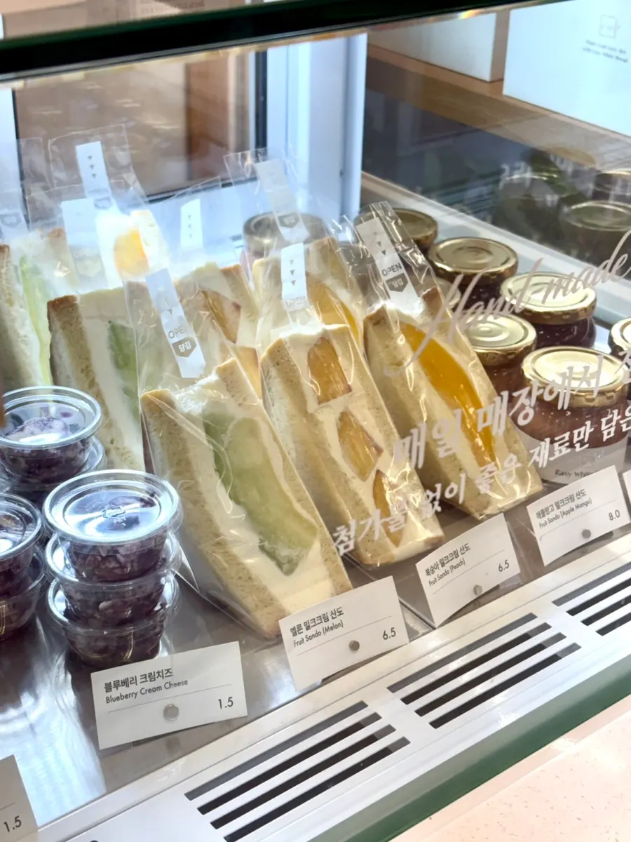 Display case with sandos, jams, and cream cheeses