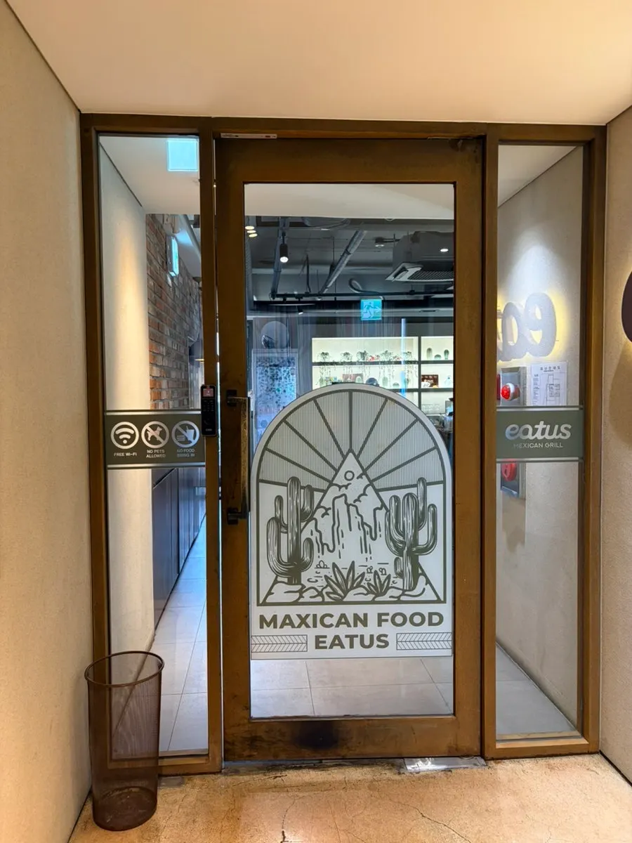 Storefront entrance with wood-toned lighting