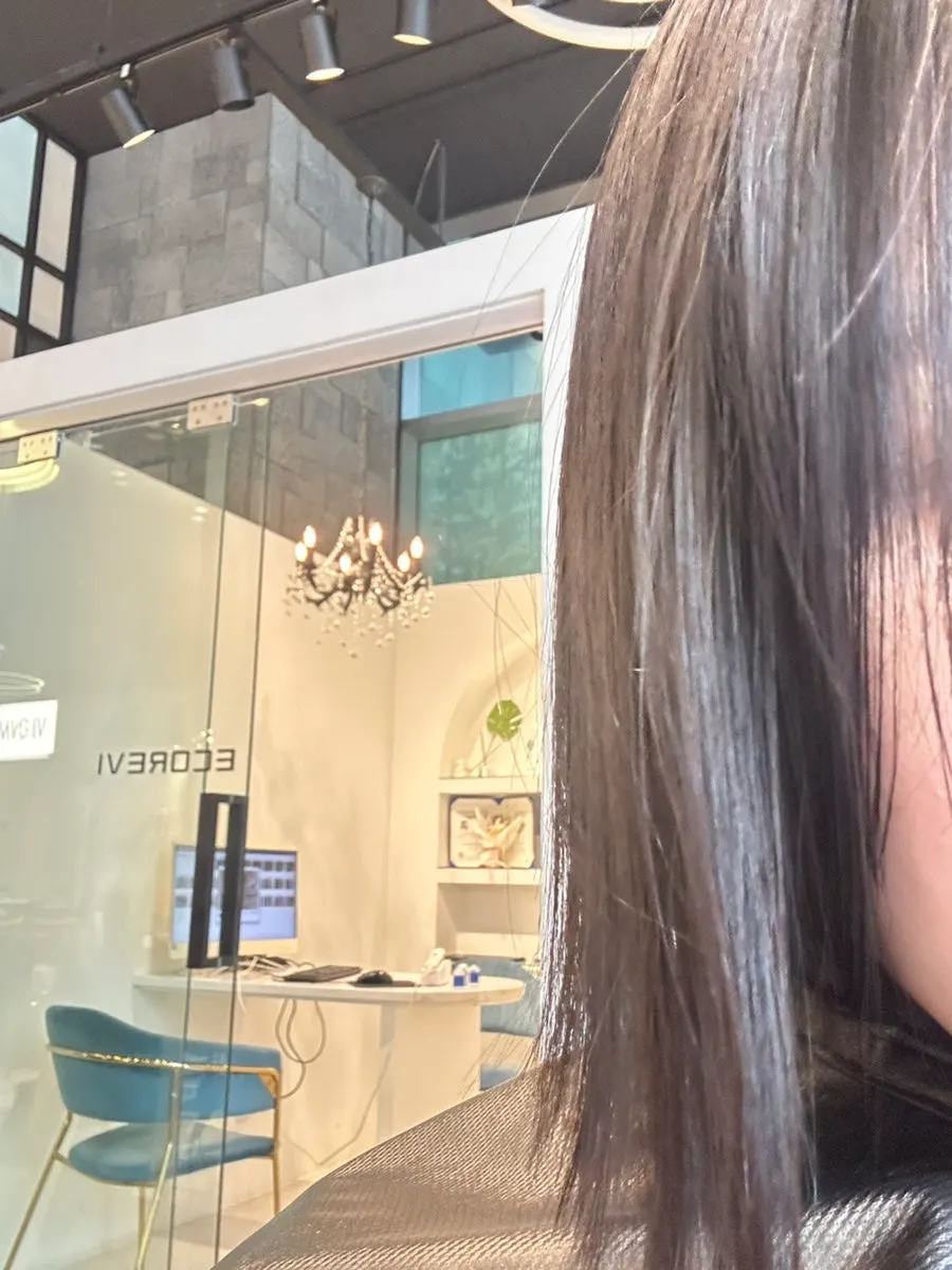Head designer performing the magic straightening treatment