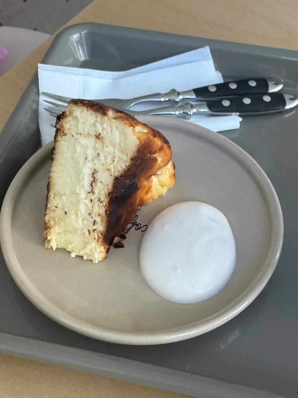 A slice of Basque cheesecake with cream