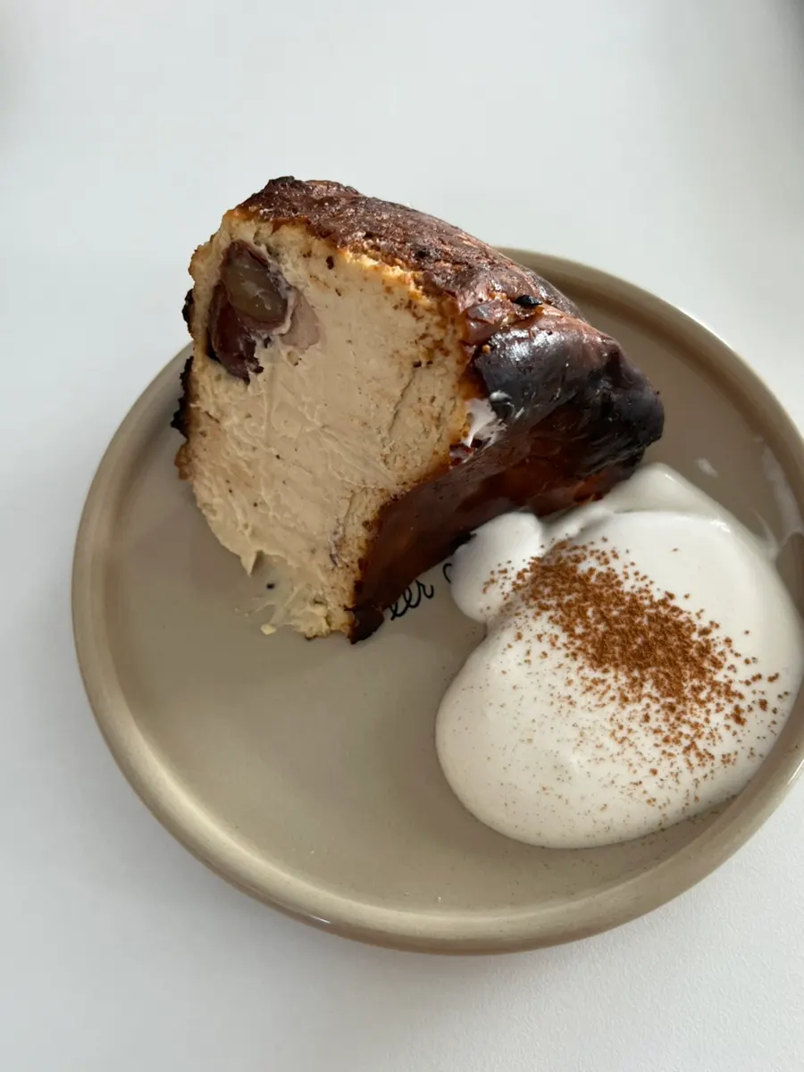 A slice of chestnut Basque cheesecake with a whole chestnut inside