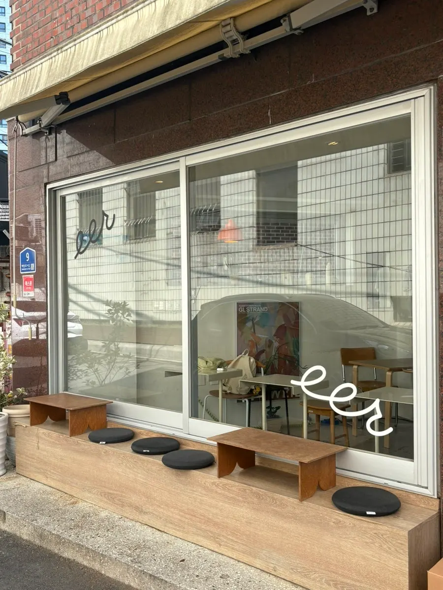 Café exterior blending softly into the alley scenery