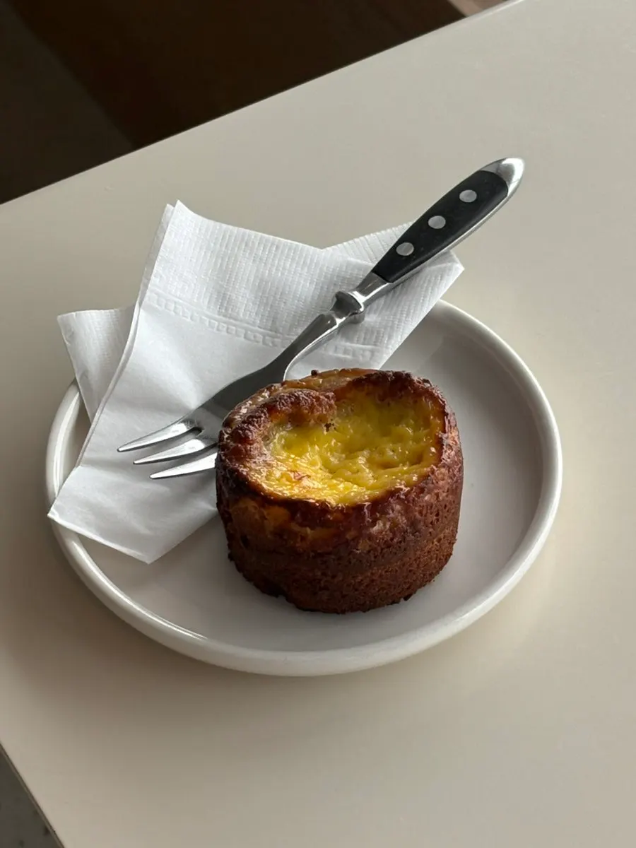 Egg financier with egg filling on top and financier base below