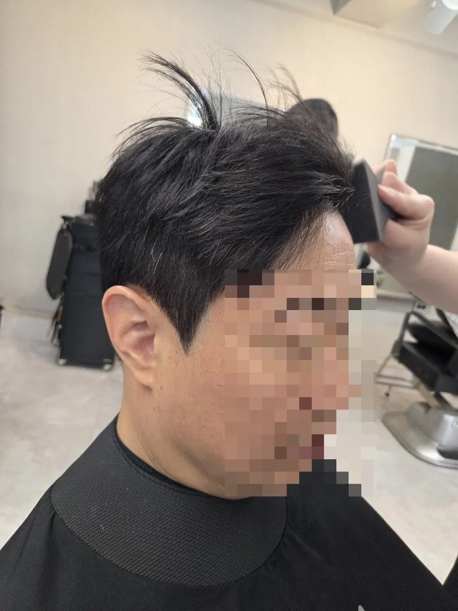 Cutting while checking the direction of hair growth at the back
