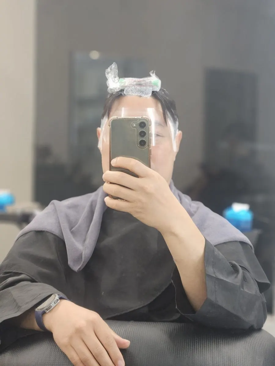 Down perm underway with a clear mask shield attached