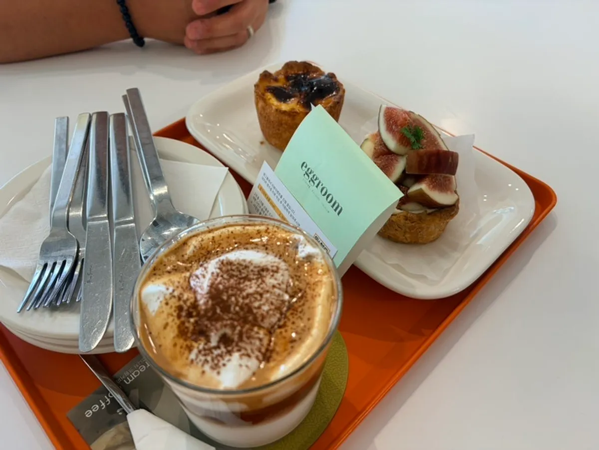 Eggroom spread of shakshuka, dessert, and almond cream latte
