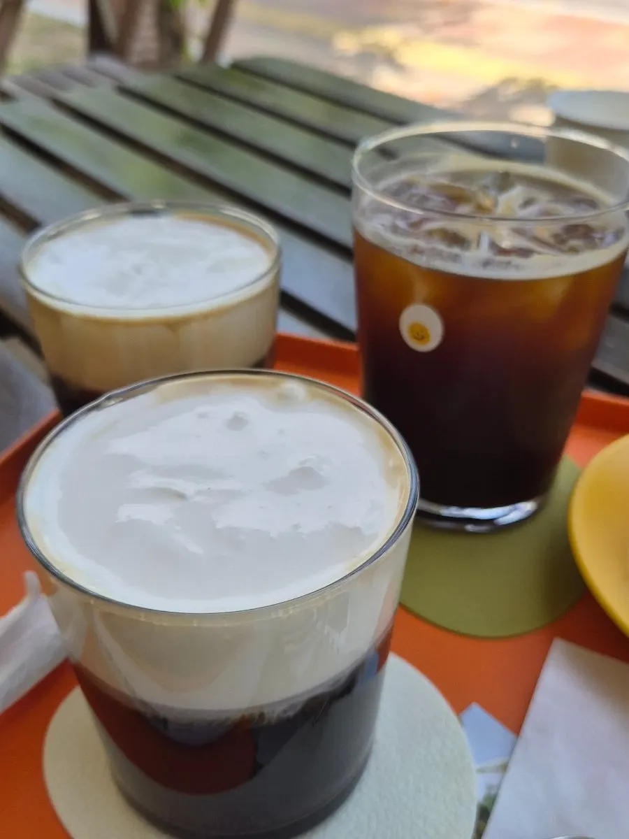Eggroom's signature latte topped with cream