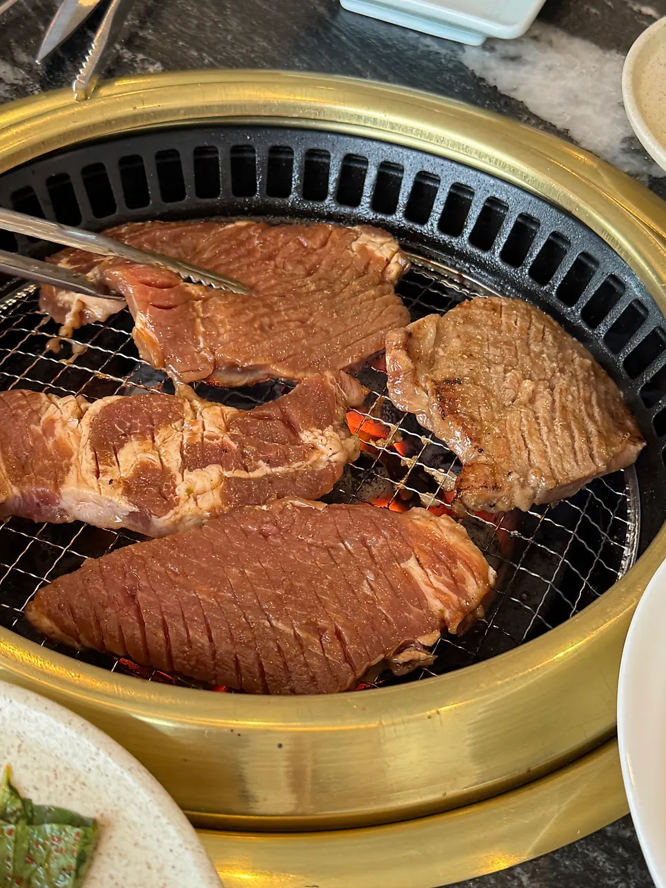 Pork ribs grilling over charcoal near Balsan Station