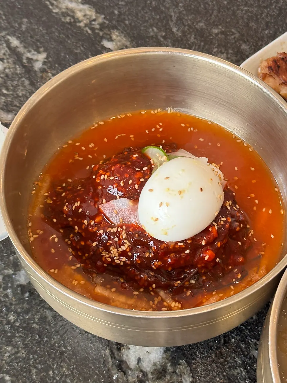 Pork ribs placed on top of bibim naengmyeon