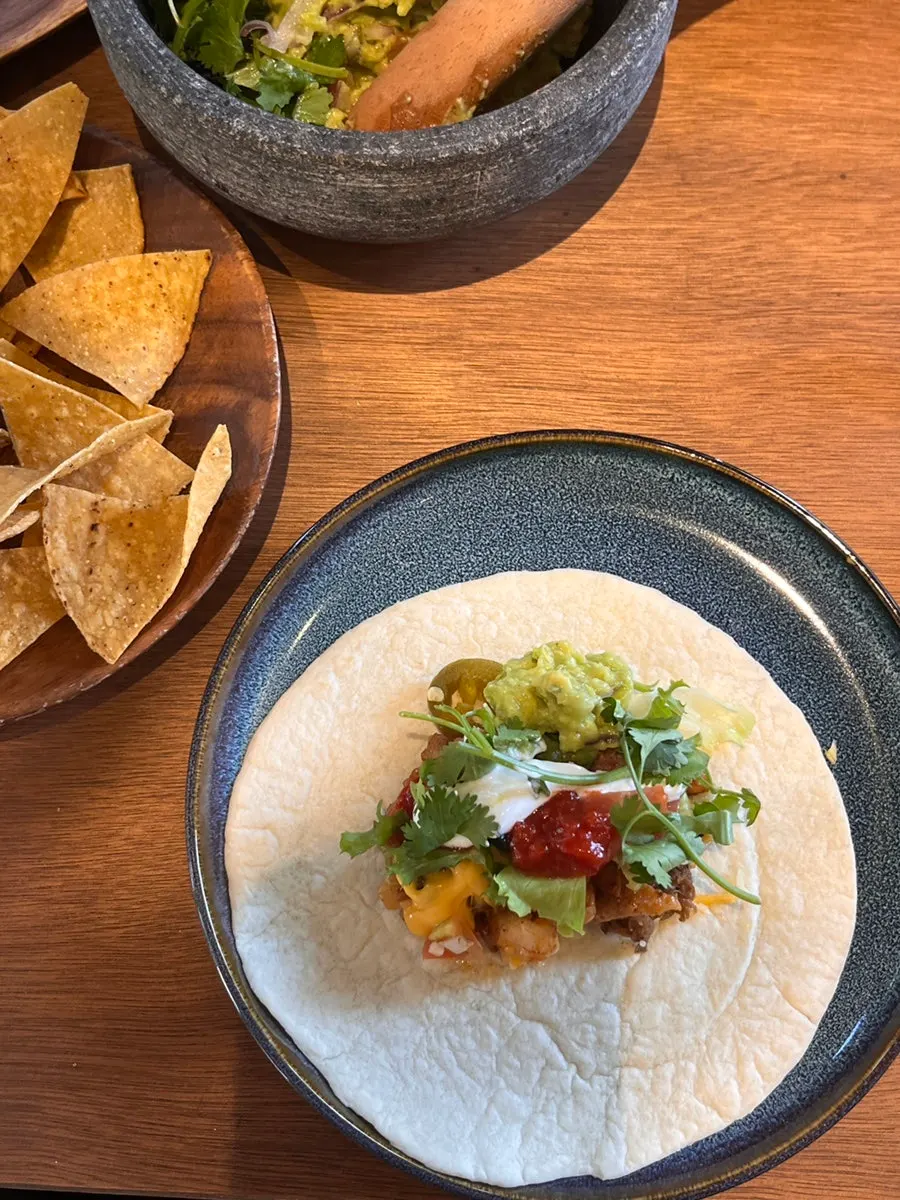 A taco assembled with toppings on a tortilla