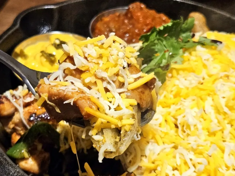 The fajita pan kept warm by a small flame underneath
