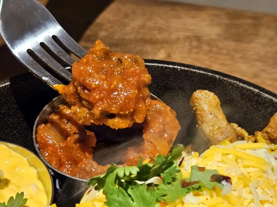 A plate of handmade sauces including tomato salsa and guacamole