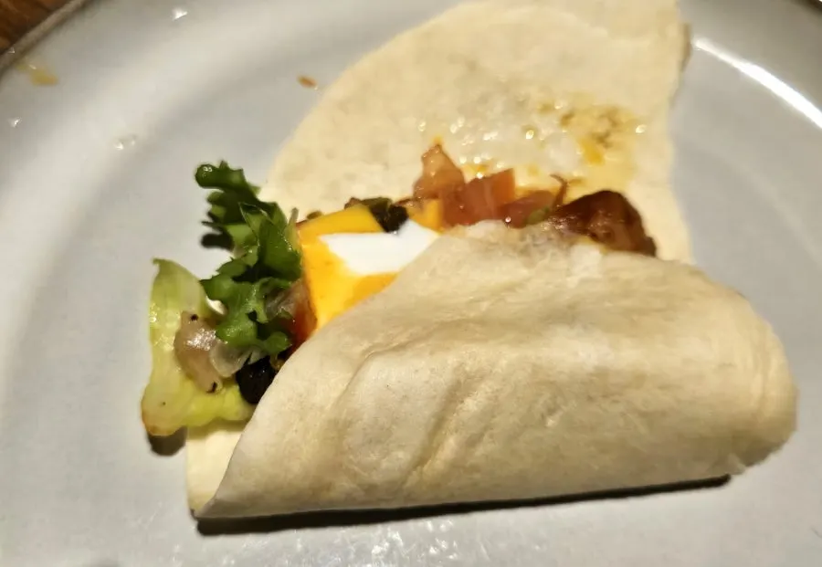 A finished fajita wrap held in hand