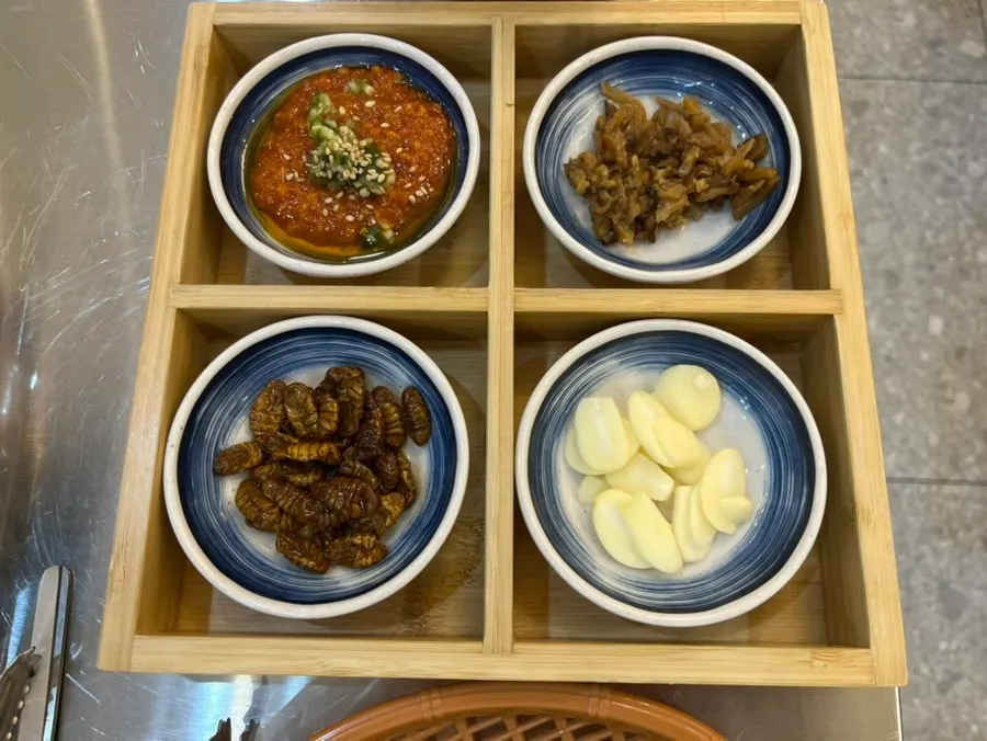 Table setting with ssamjang, garlic, and perilla leaves