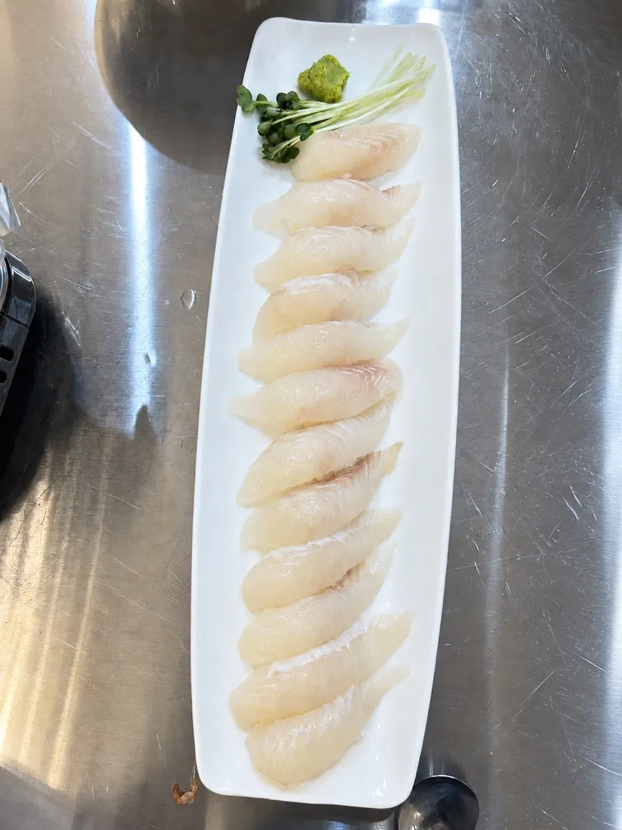 A serving of thickly sliced flounder sushi