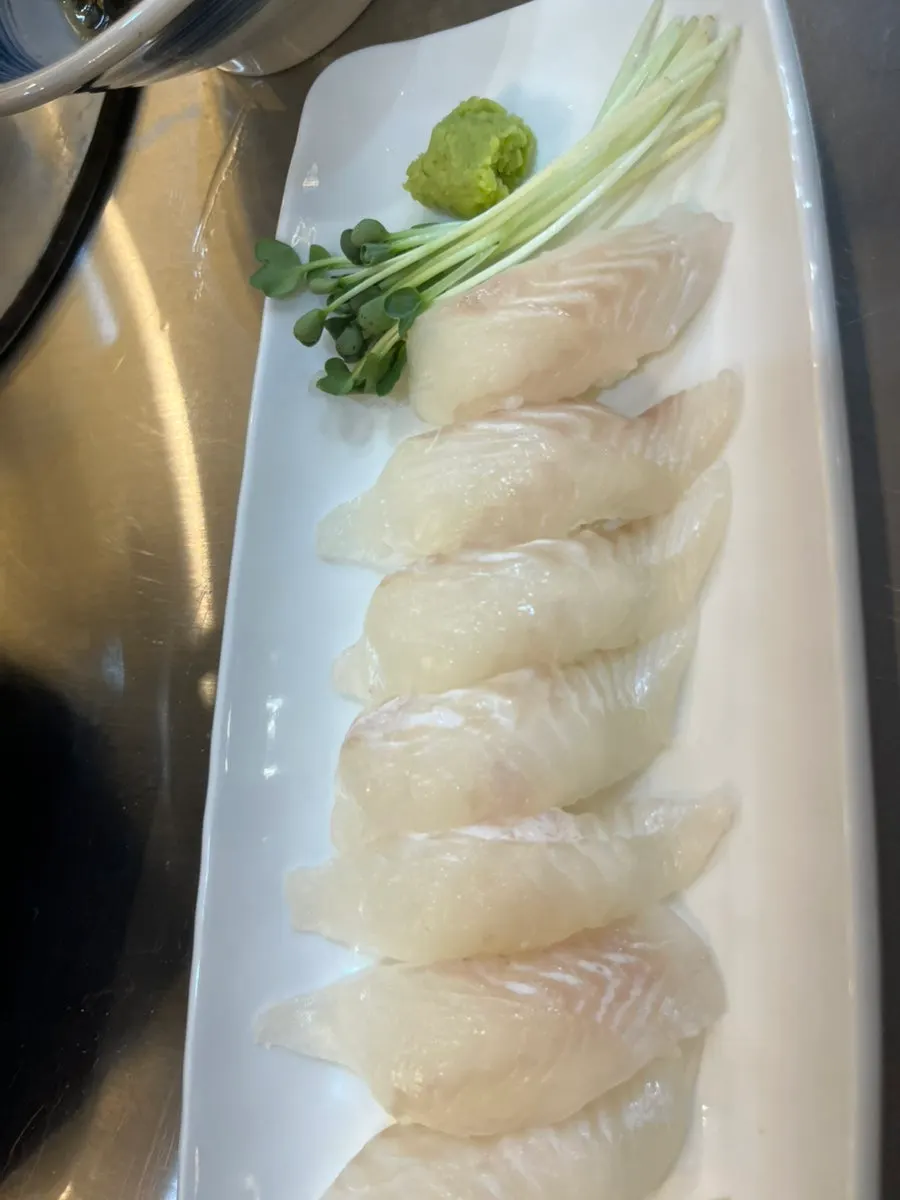 Flounder sushi served with wasabi and radish sprouts