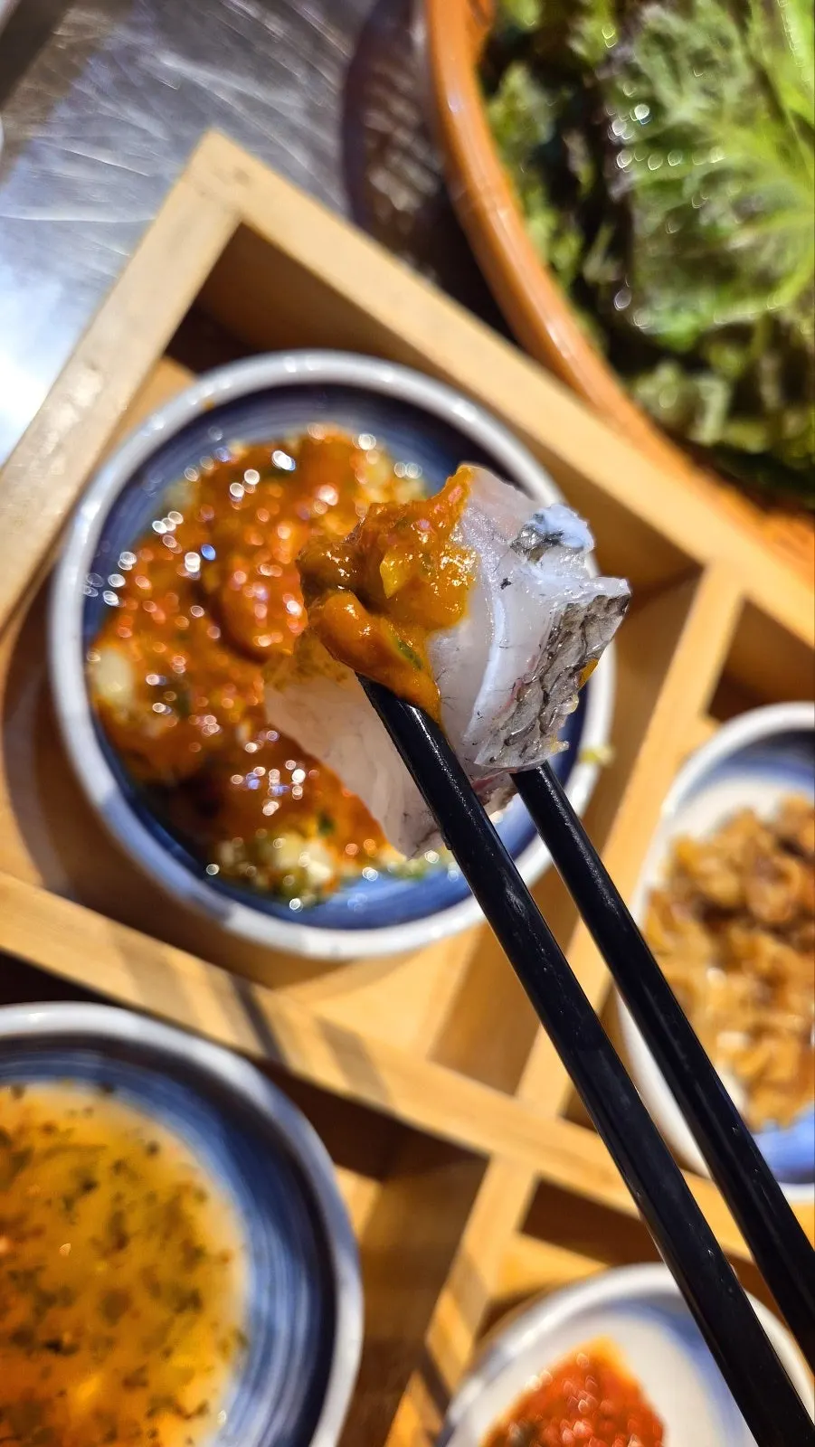 A piece of red snapper sashimi with a bouncy texture
