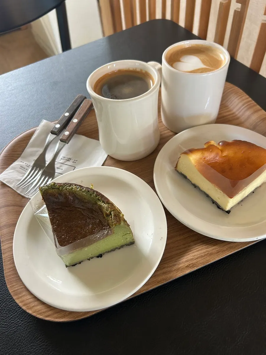 Basque cheesecake and coffee served on a wood tray