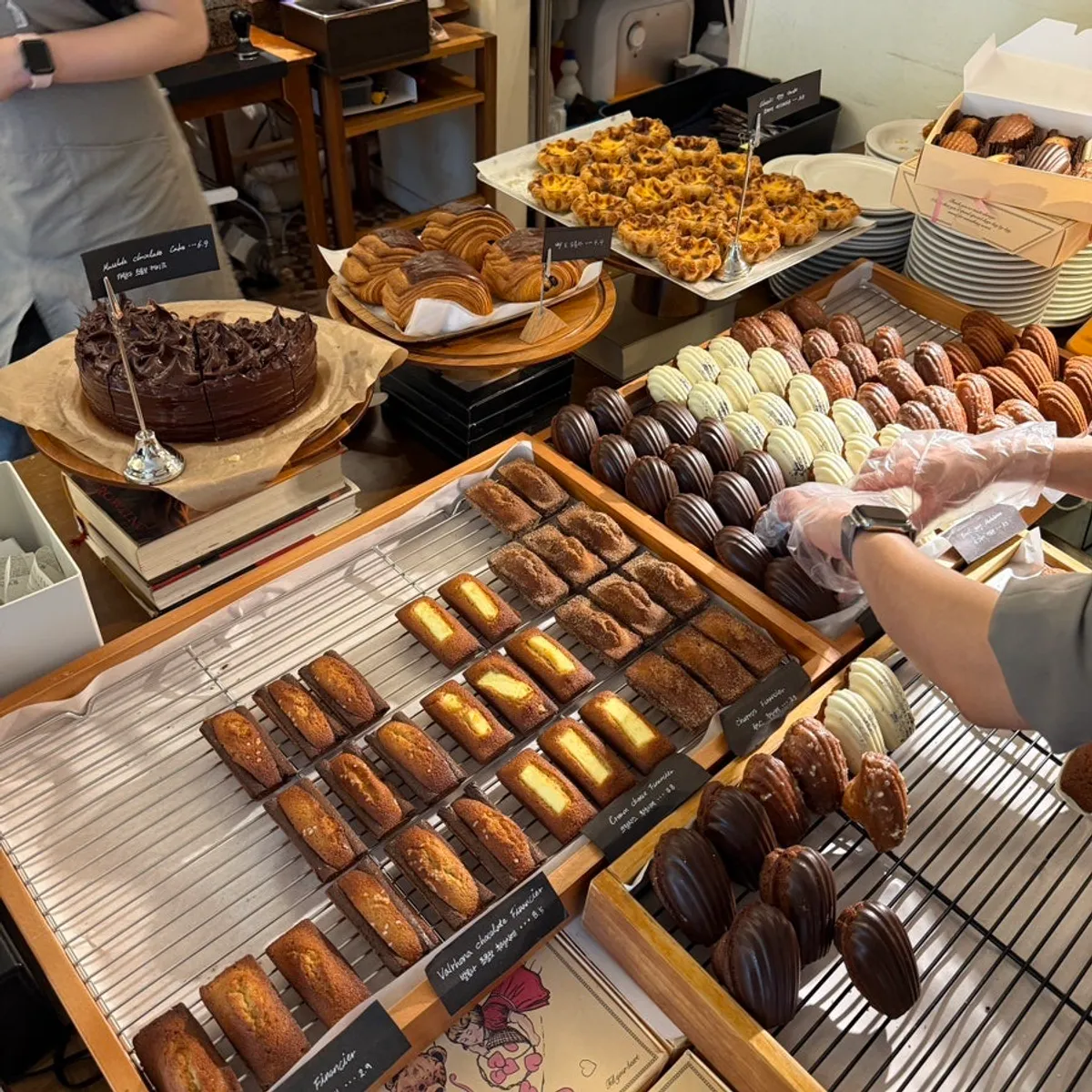 Table spread of Eojil In's homemade cola, lemon ade, egg tart, and lemon madeleine