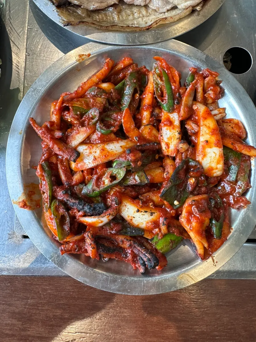 A piece of bulgogi with a bowl of rice