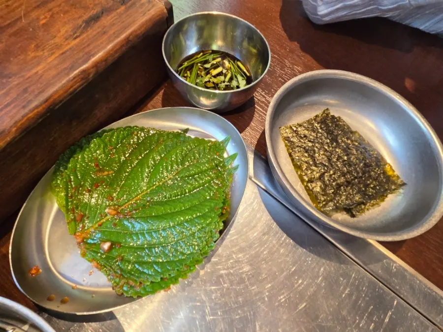 Namul side dishes including young radish greens and stir-fried bean sprouts