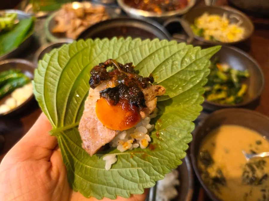 Charcoal bulgogi, rice, and myeolchi jorim wrapped in a leaf