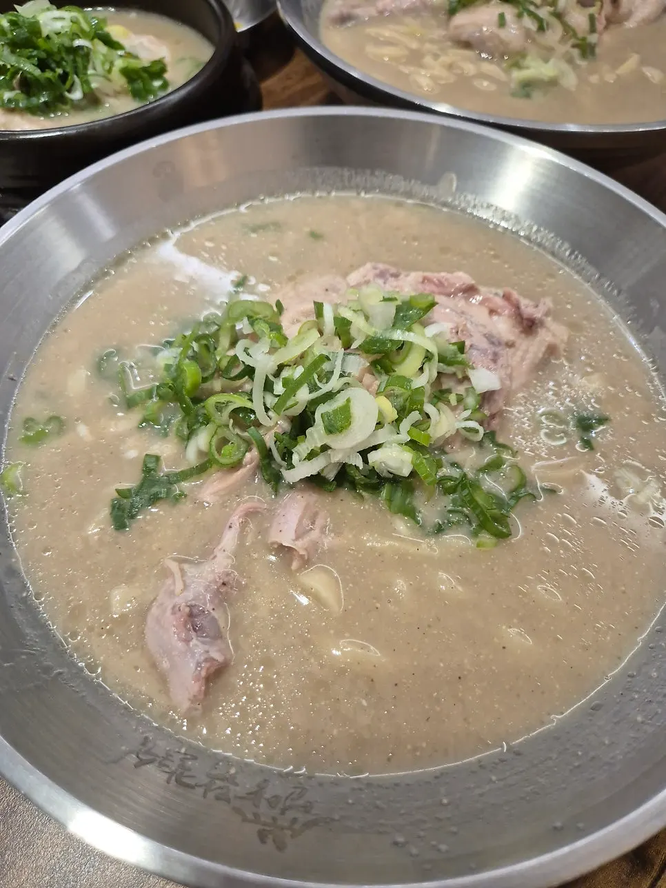 A bowl of dak kalguksu with milky broth