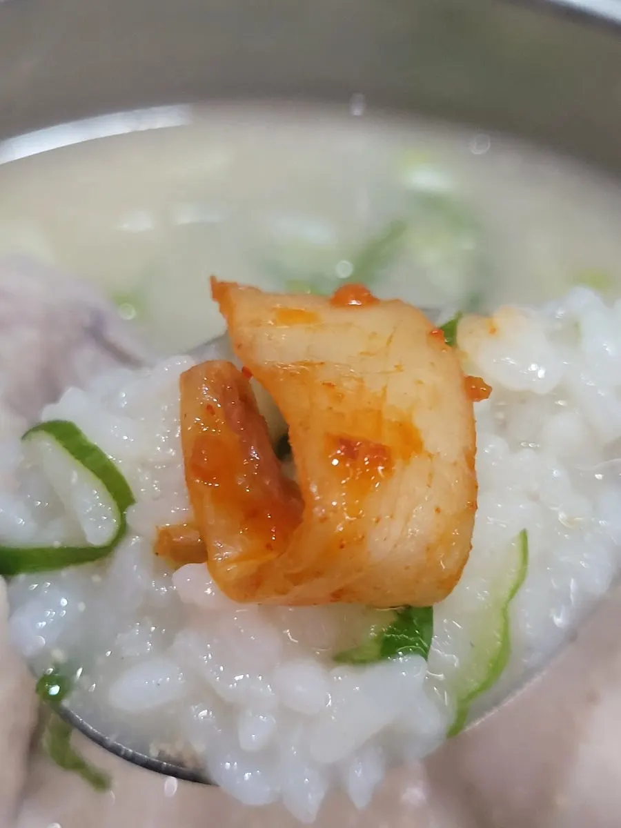 Topping the kalguksu noodles with kimchi