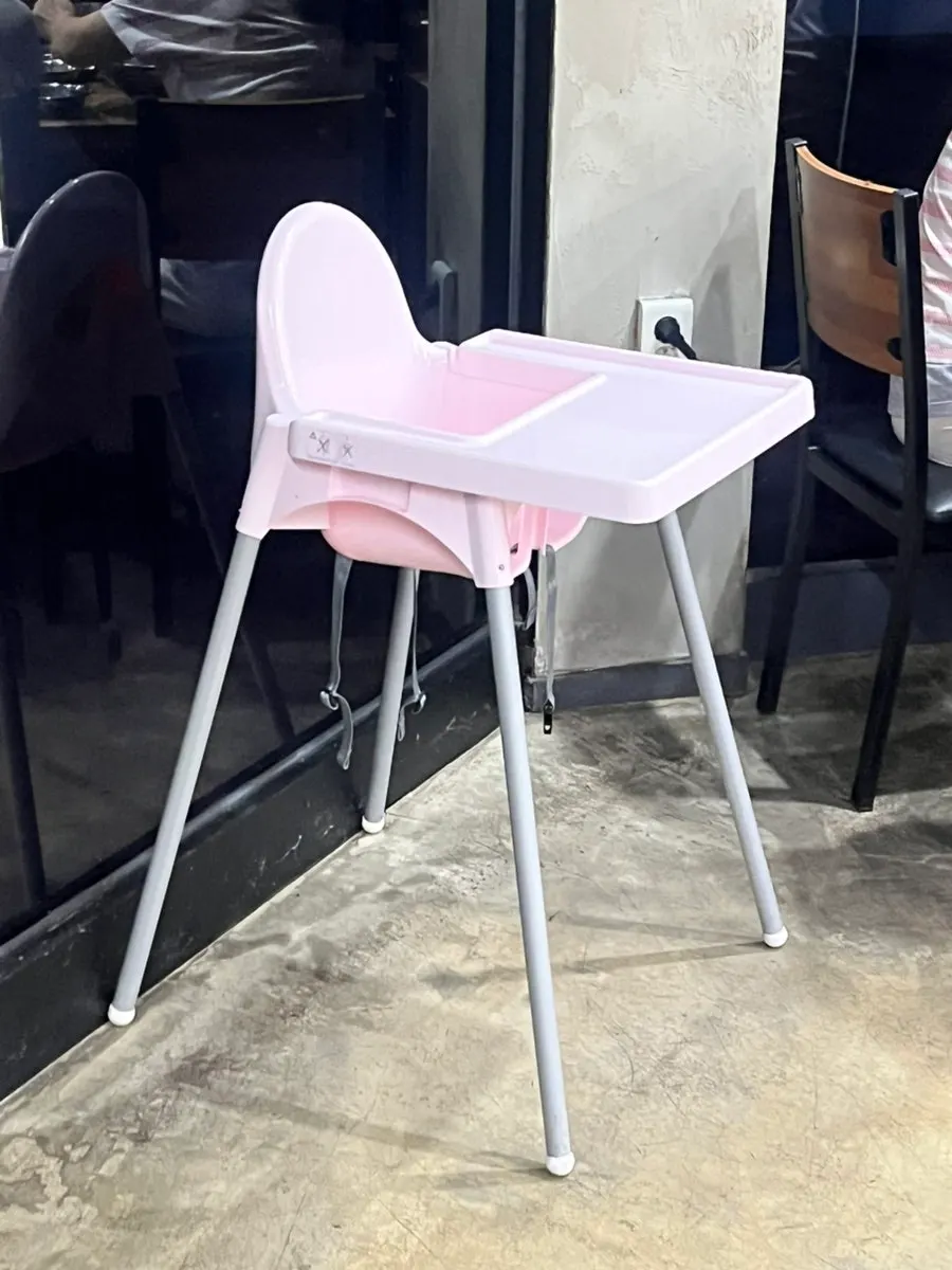 Aprons and baby chairs set up in one corner of the restaurant