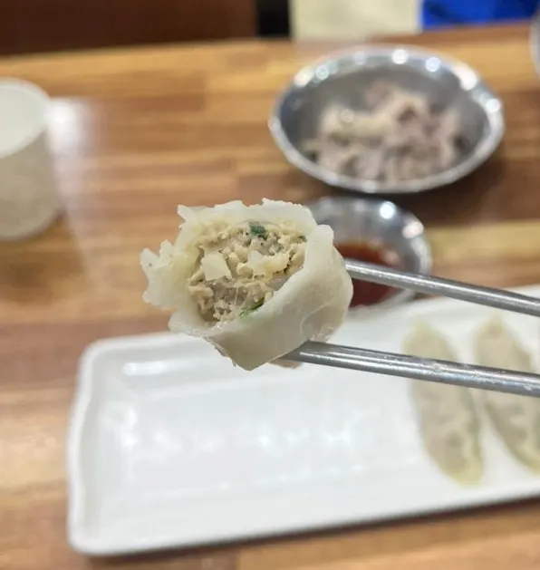 A mandu cut in half showing the filling