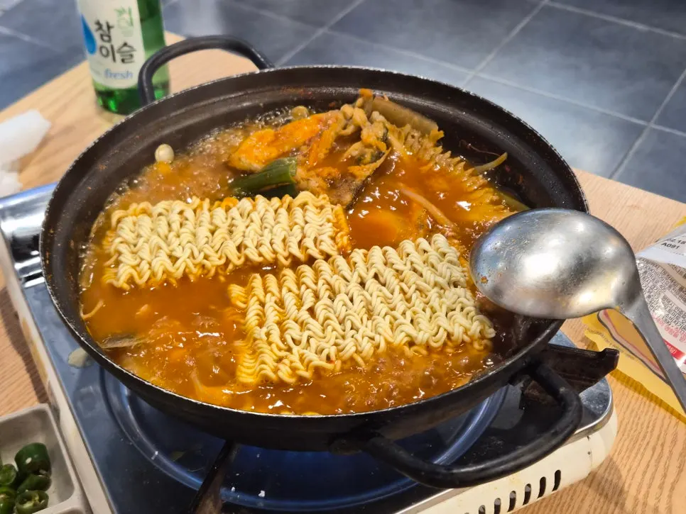 Spicy fish stew boiling on a portable burner
