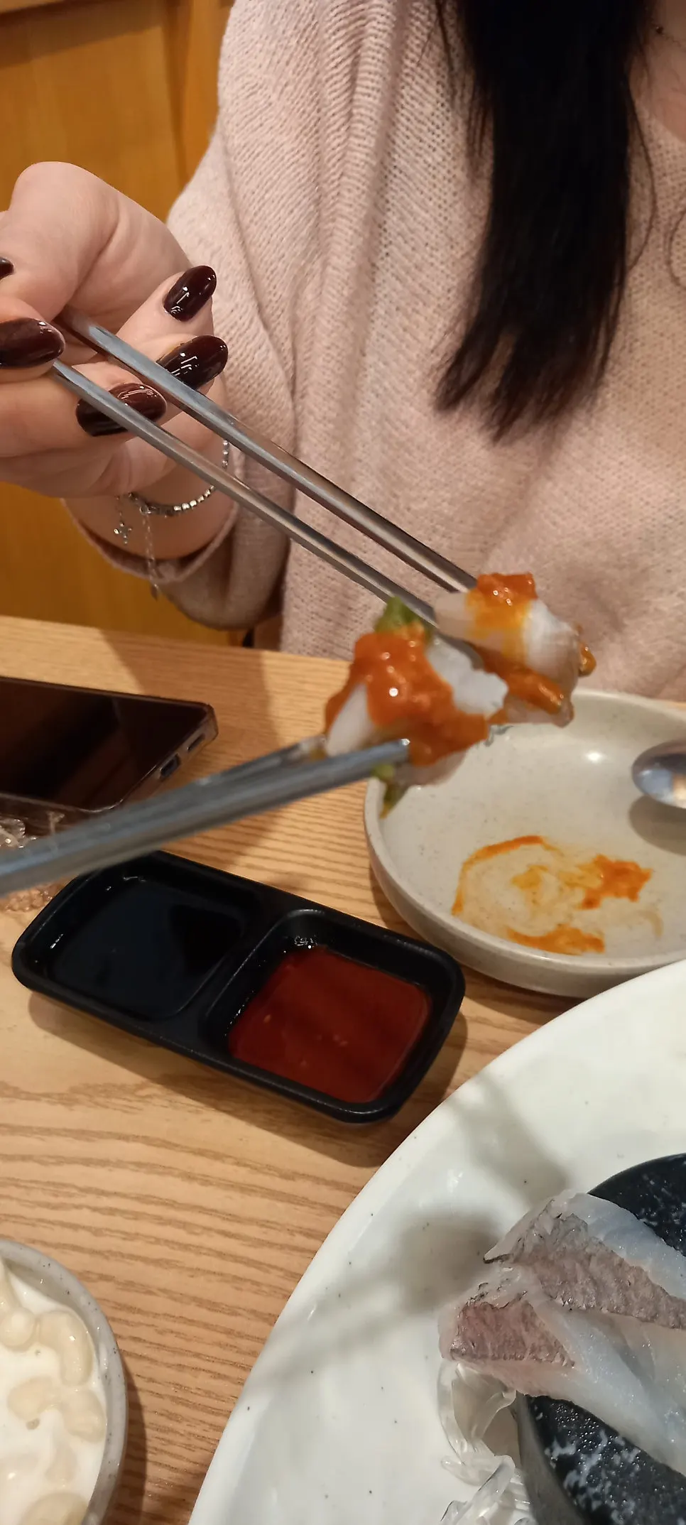 상추에 회 두 점과 마늘 쌈장을 올린 쌈
