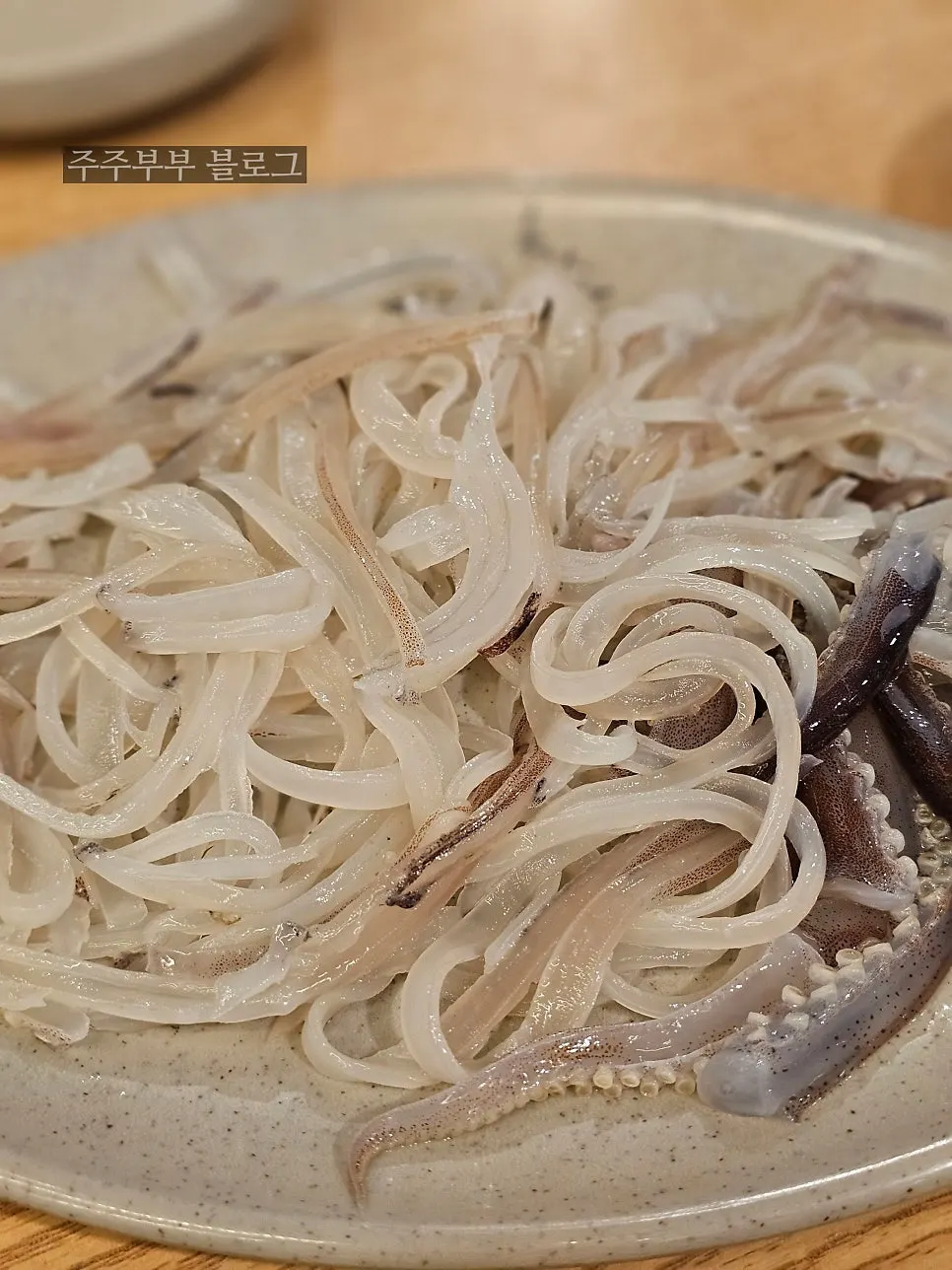 A generous plate of live squid sashimi