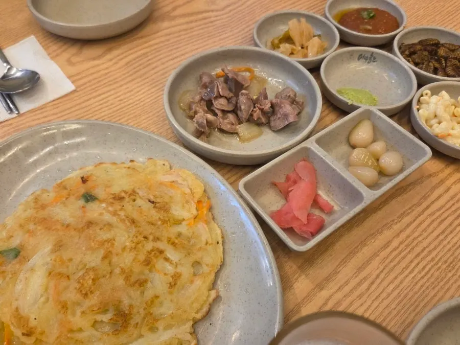 Banchan spread served after ordering the seasonal assorted sashimi
