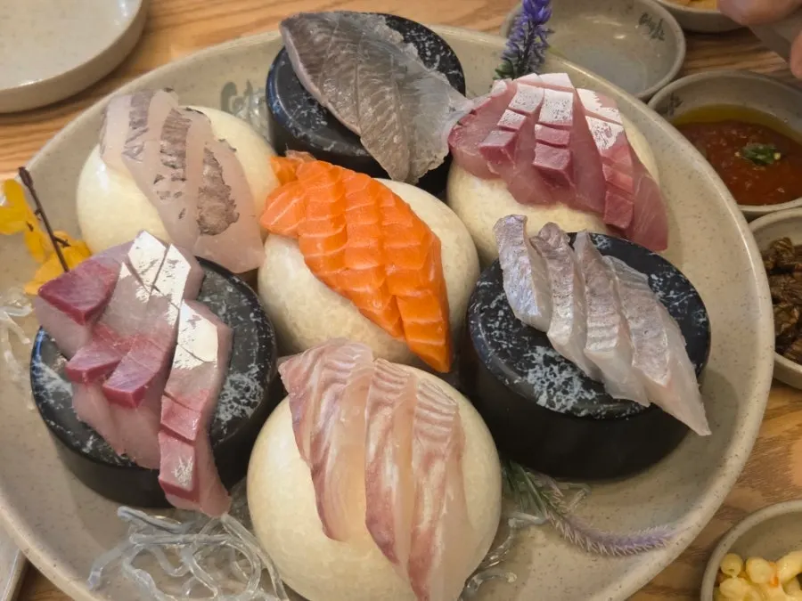 Table set with sashimi and drinks