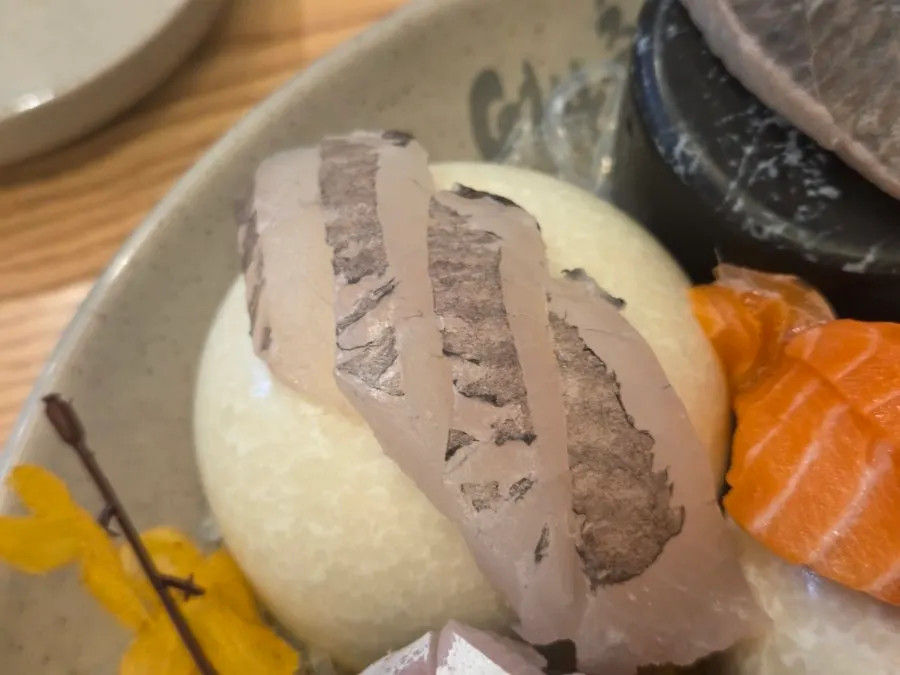 Picking up a piece of sashimi