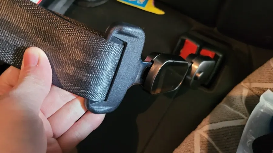 Seat belt clip in use with a child car seat