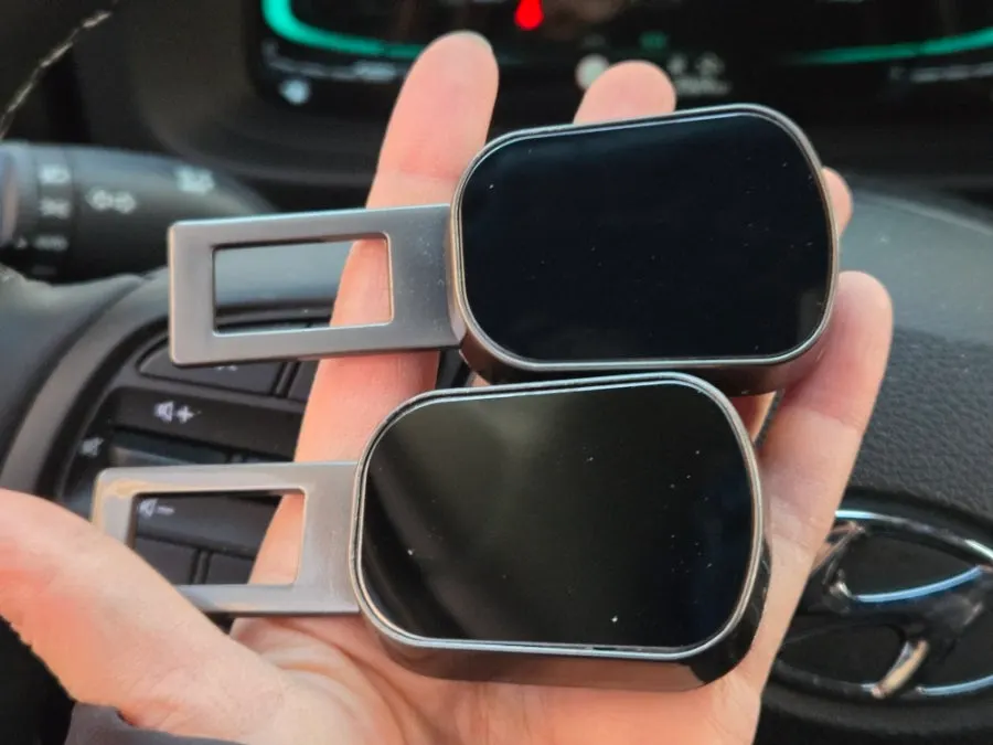 Two seat belt extender clips inside the box
