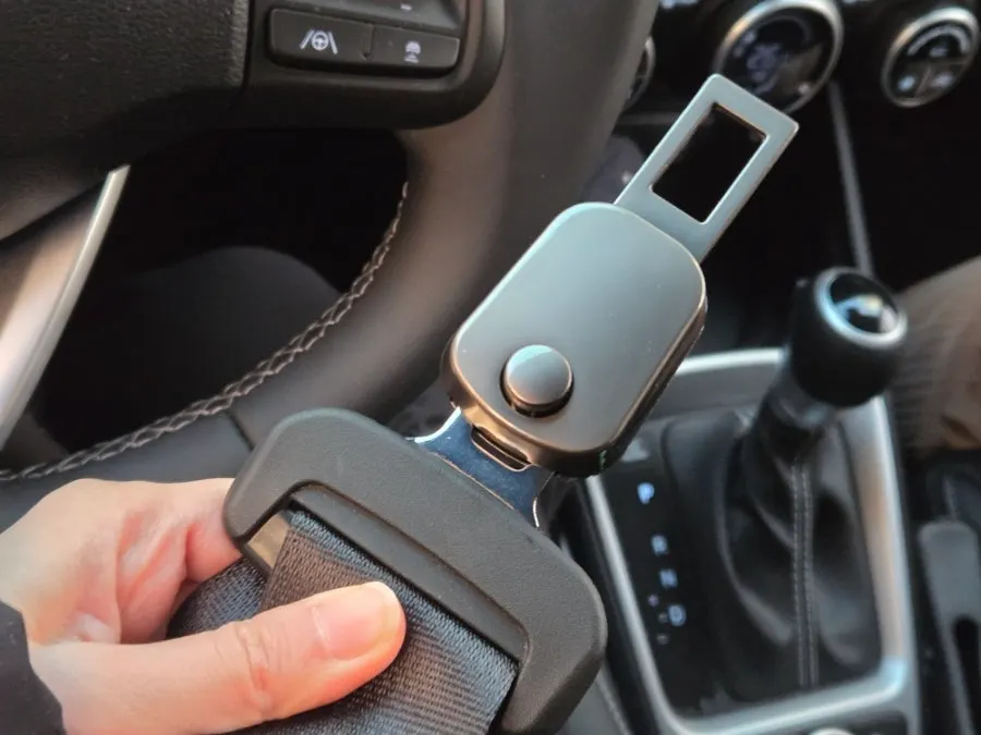 Regular seat belt connected to an extender clip