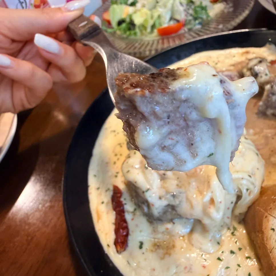 A piece of steak dipped in cream sauce