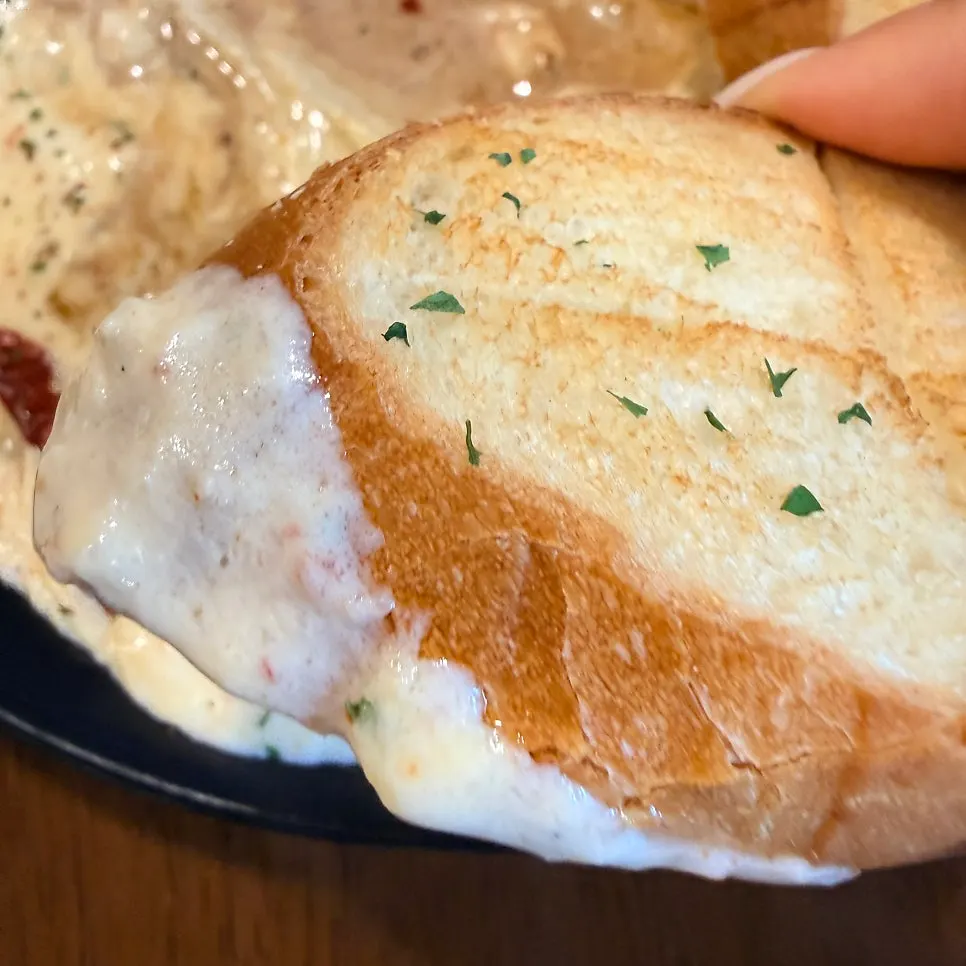 Baguette dipped into the leftover cream sauce