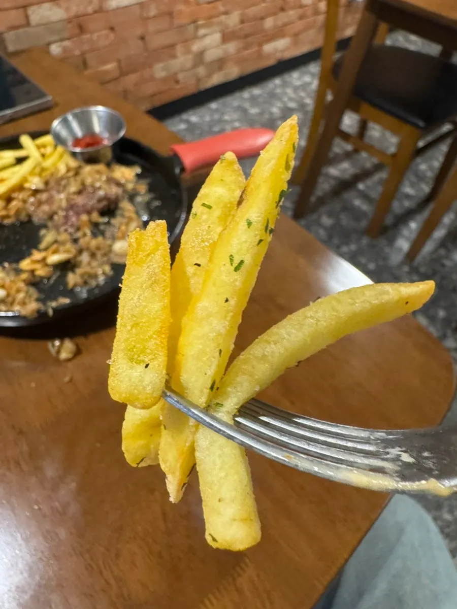 A piece of steak with french fries