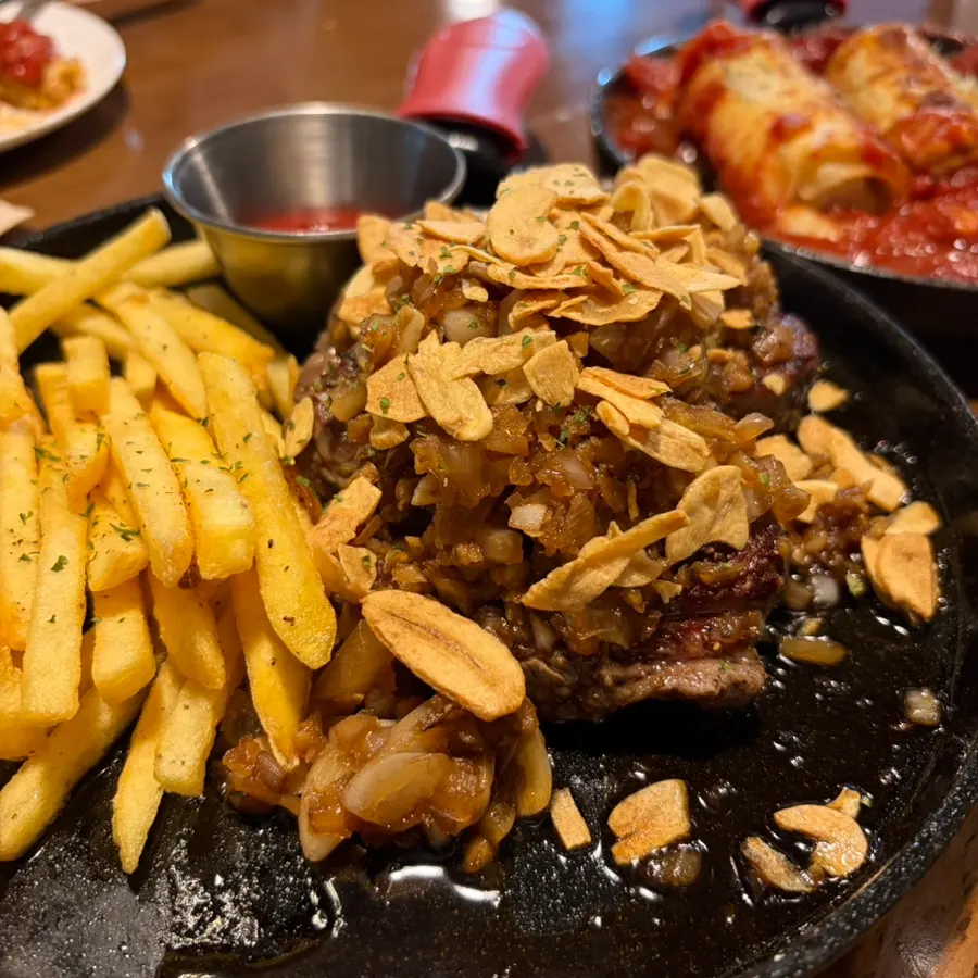 Mammoth Garlic Steak topped with garlic flakes