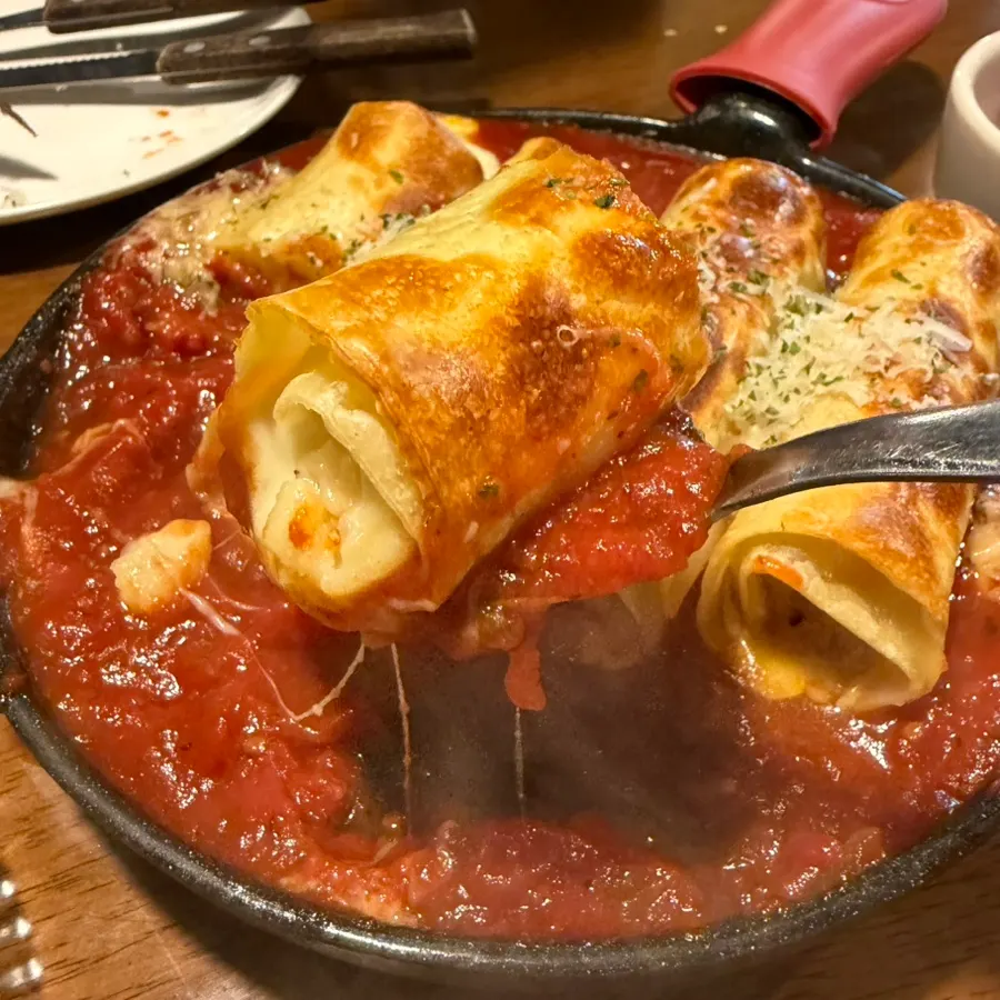 Table with steak and lasagna served together