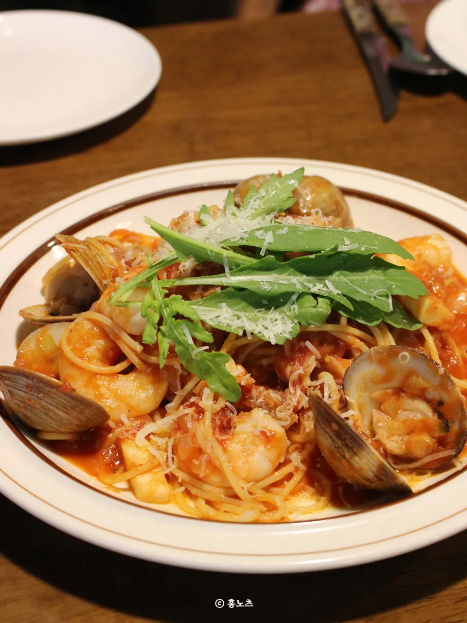 A plate of seafood tomato pasta