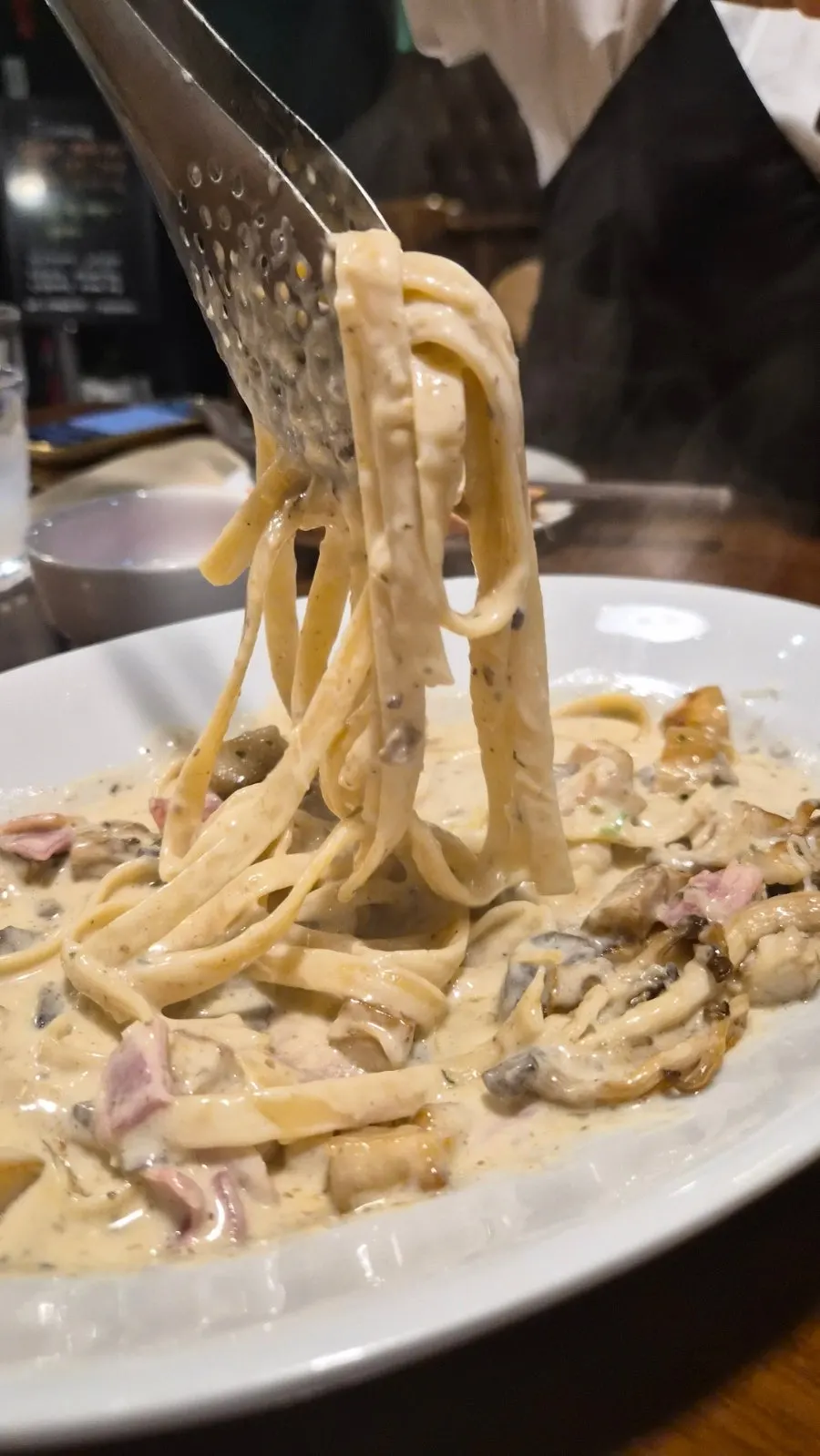 Mushroom cream pasta being served