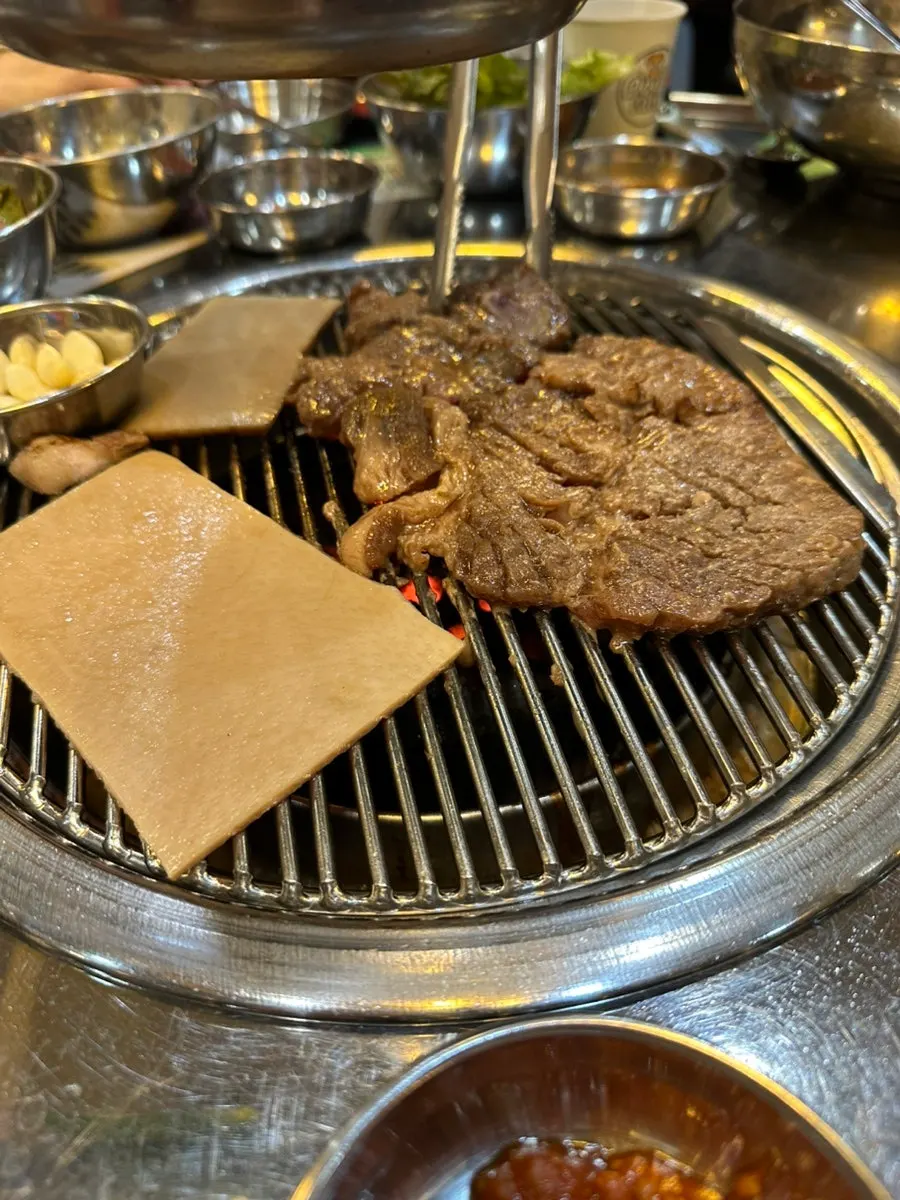 Seasoned pork galbi and pork skin on the charcoal grill
